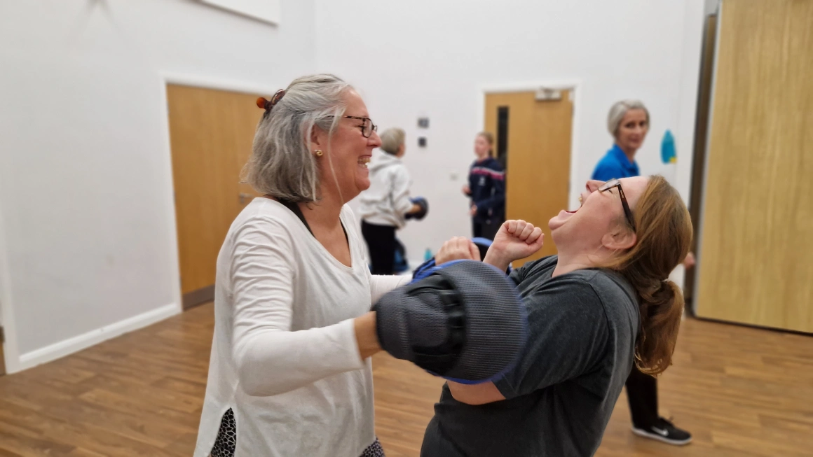 Two ladies laughing together